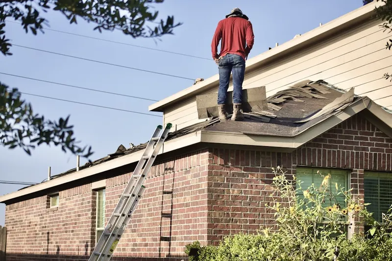 Professional roofer working on a residential roof in Near Northeast